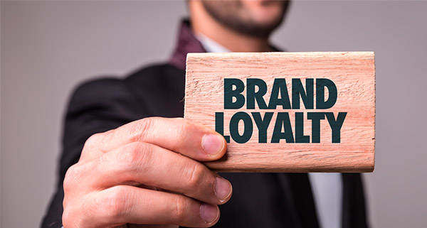 image of a man holding Brand Loyalty block