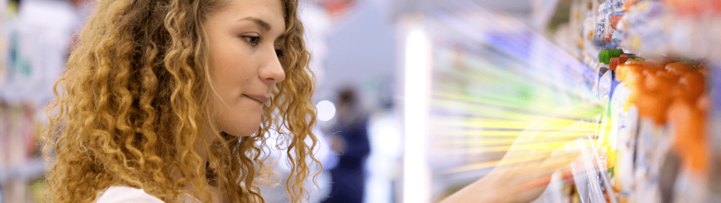 banner image of a woman shopping in the grocery store